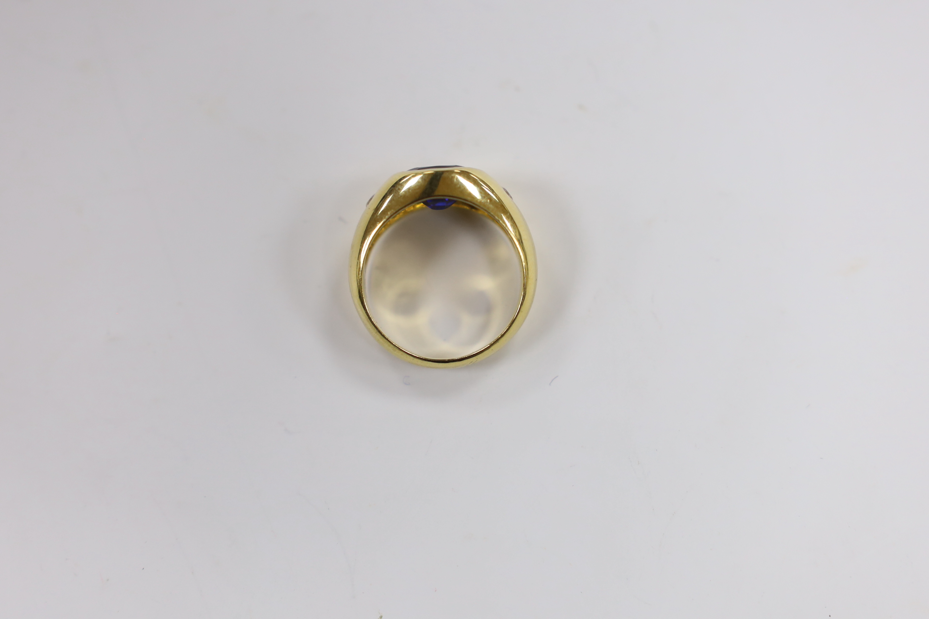 A 750 yellow metal, synthetic sapphire? and two stone simulated diamond gypsy set ring, size K, gross weight 7.8 grams.